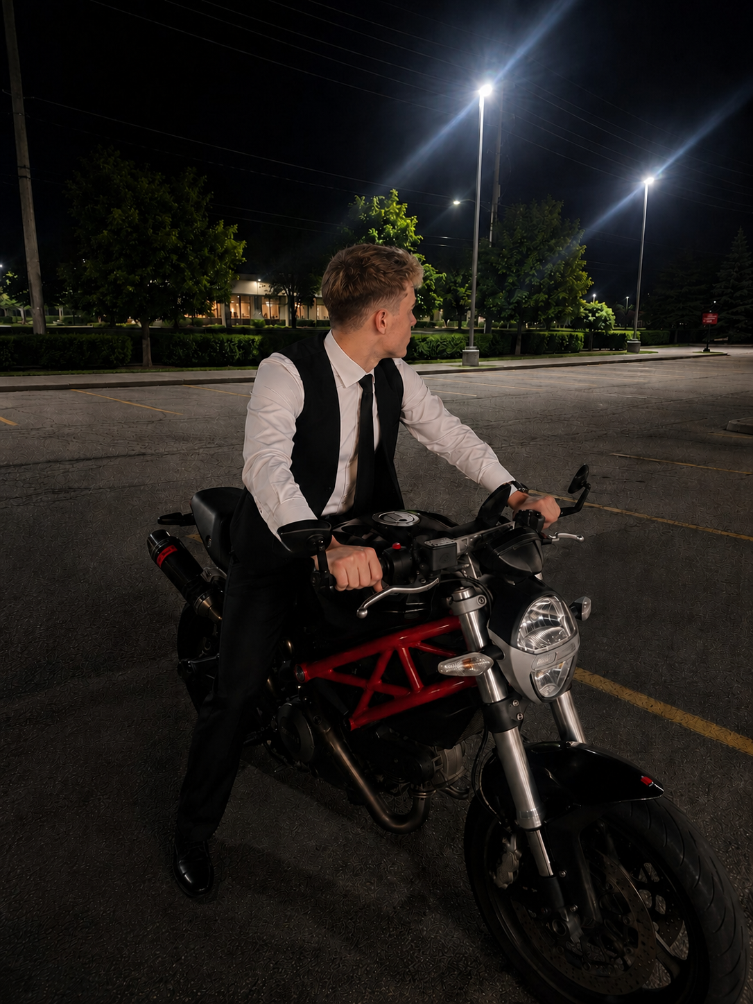 Rostyslav sitting on a motorcycle at night