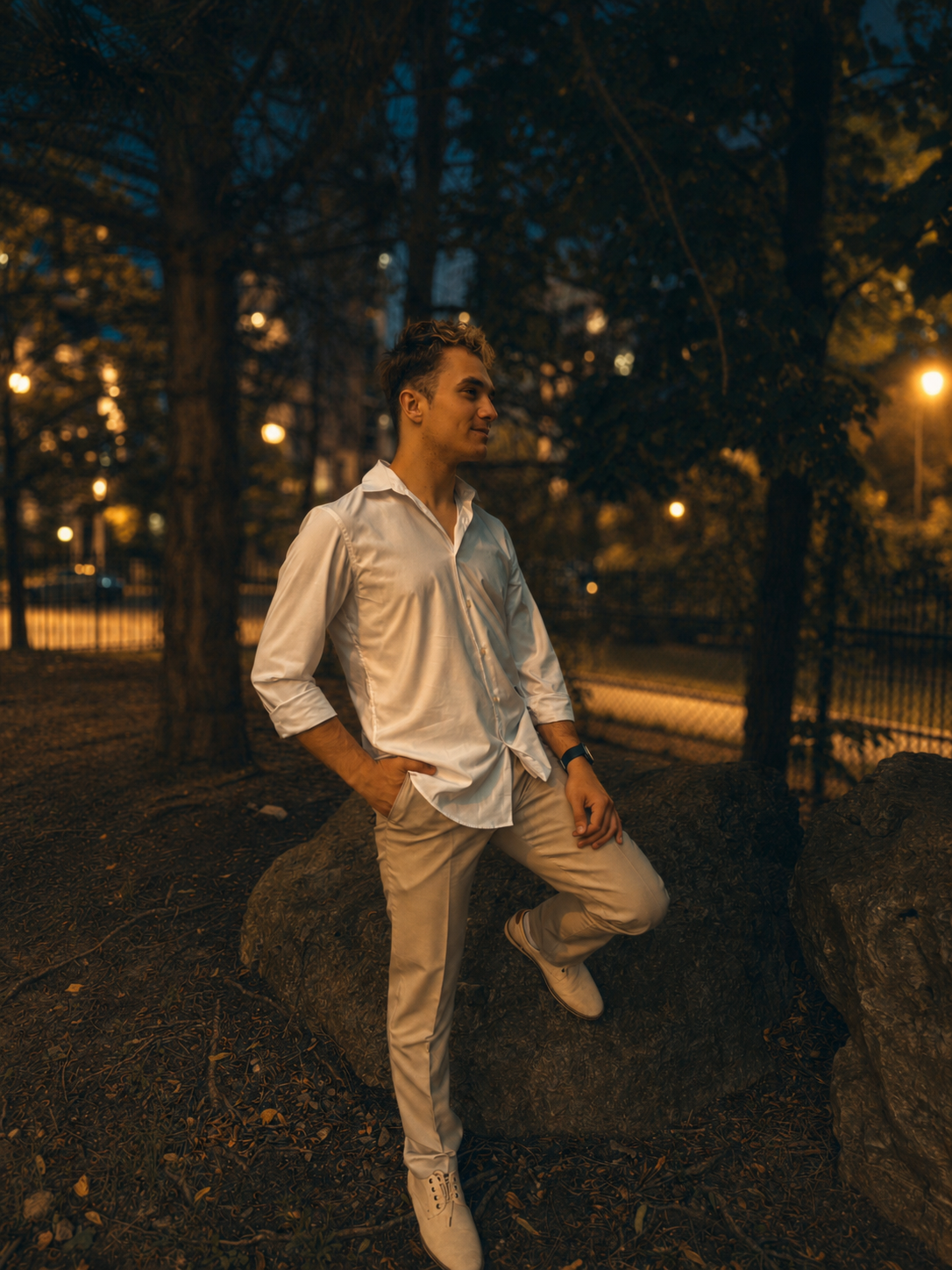 Rostyslav standing outdoors at night in warm city lights